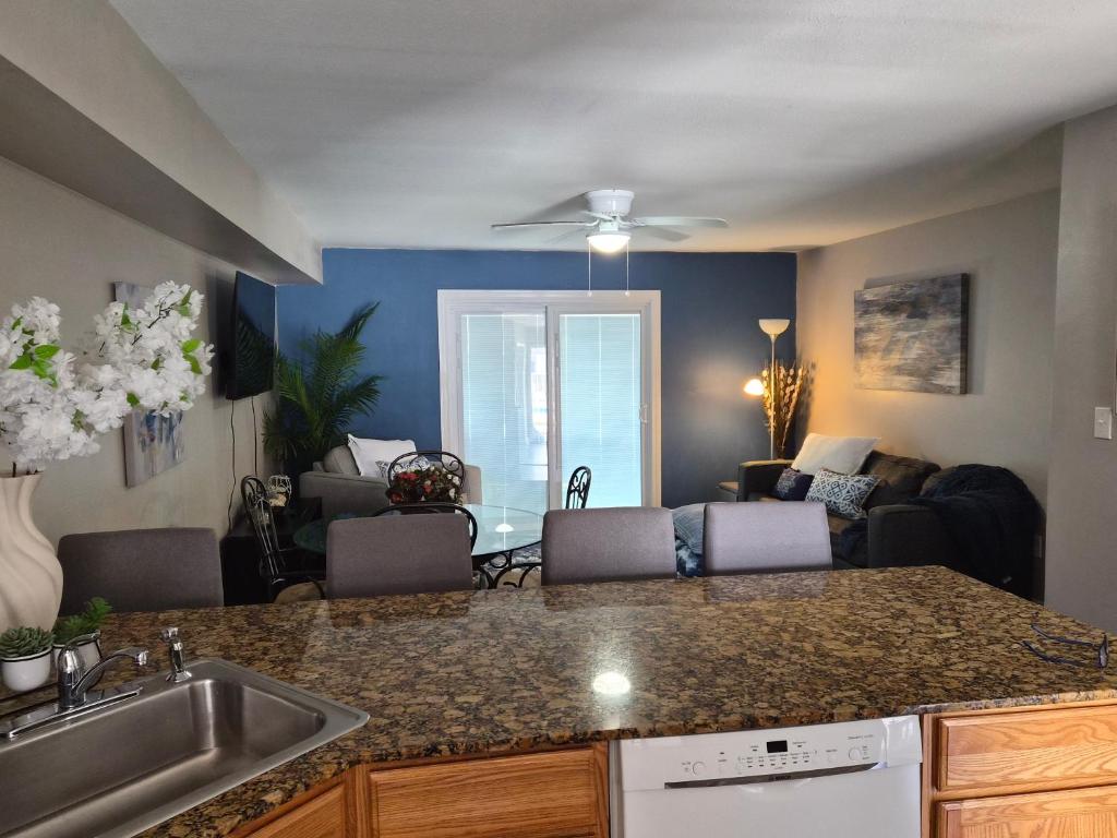 a kitchen with a sink and a living room at Best location Cozy condo in Biloxi Beach in Biloxi
