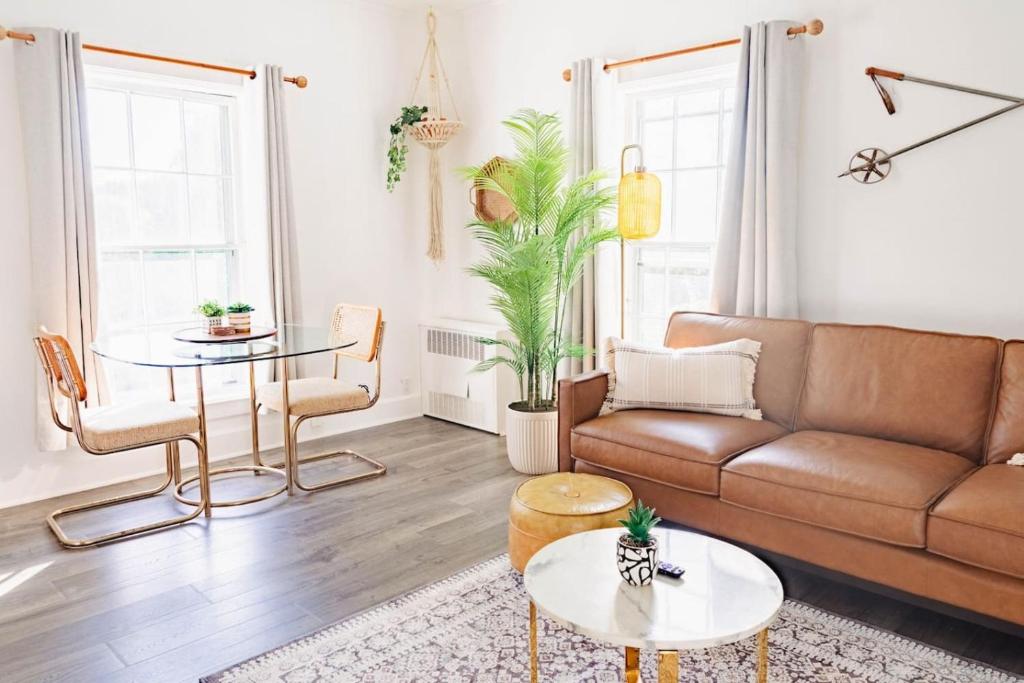 a living room with a couch and a table at Sweet Stowe Apartment in Stowe