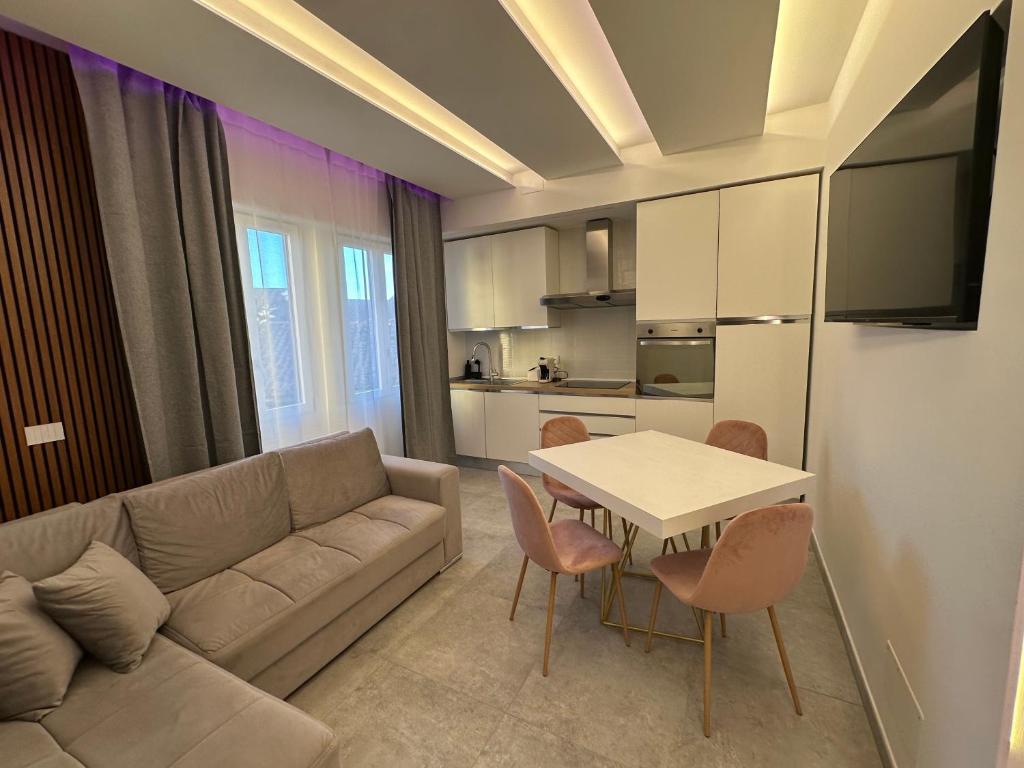 a living room with a couch and a table with chairs at Residenza del Lago in Viverone