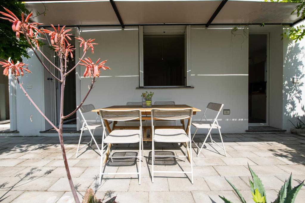 a wooden table and chairs on a patio at La casa di Guido in San Giovanni in Marignano