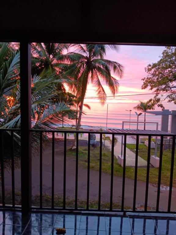 a view of a palm tree from a balcony at Sunrise Inn in Puerto Armuelles