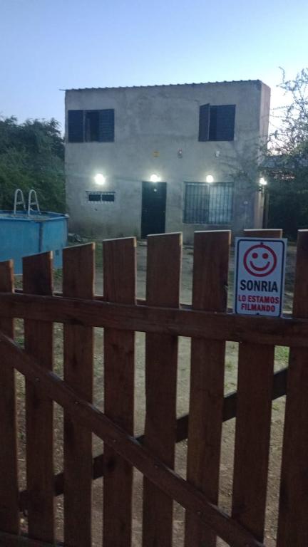 a sign on a fence in front of a building at Sierras Cosquin in Cosquín