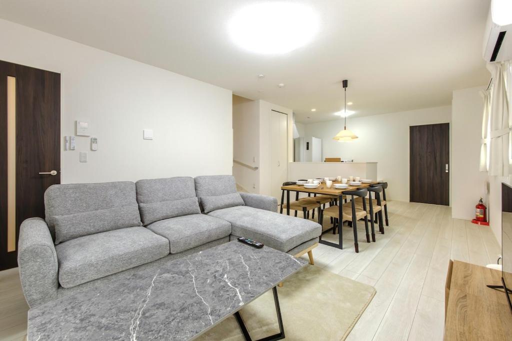a living room with a couch and a table at AsobiStay児玉藤 in Nagoya