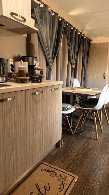 a kitchen with a table and a dining room at Glykofilousa Tiny Ηouse in Petra
