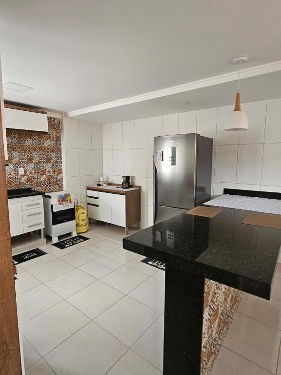 a kitchen with a refrigerator and a counter in it at Zanotti's House in Santa Teresa