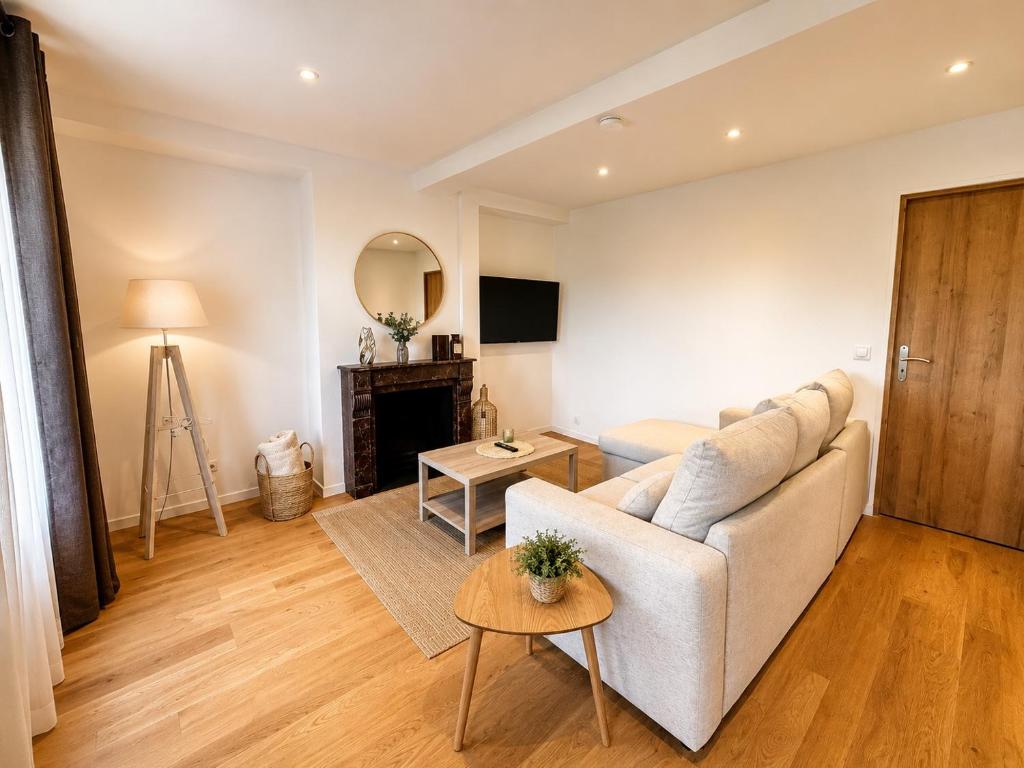a living room with a couch and a table at Au Morvan Voyageur in Asquins