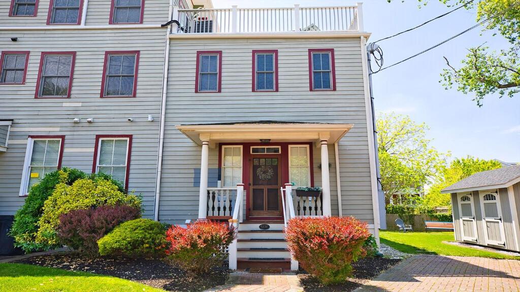 a white house with a door and a porch at Summer Winds Sanctuary in Cape May