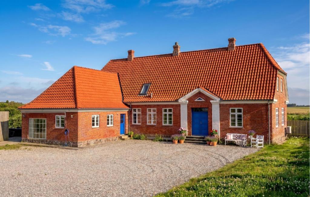 a red brick house with an orange roof at Lovely Home In Lemvig With Wifi in Lemvig