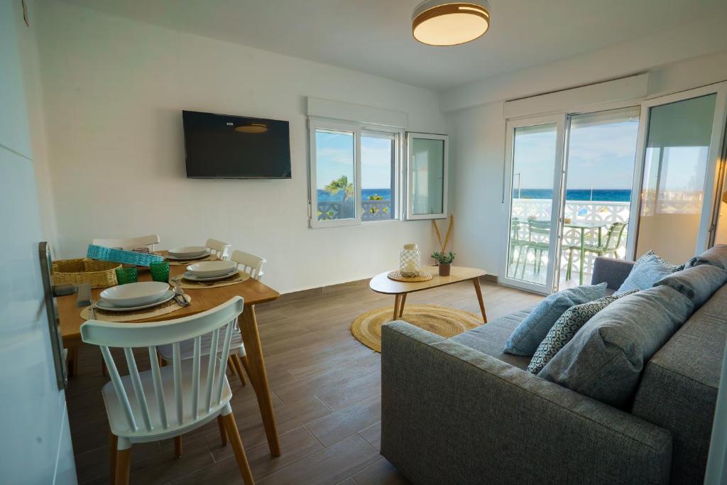 a living room with a couch and a table at Ap Turísticos Marea - Frente al Mar in Mojácar
