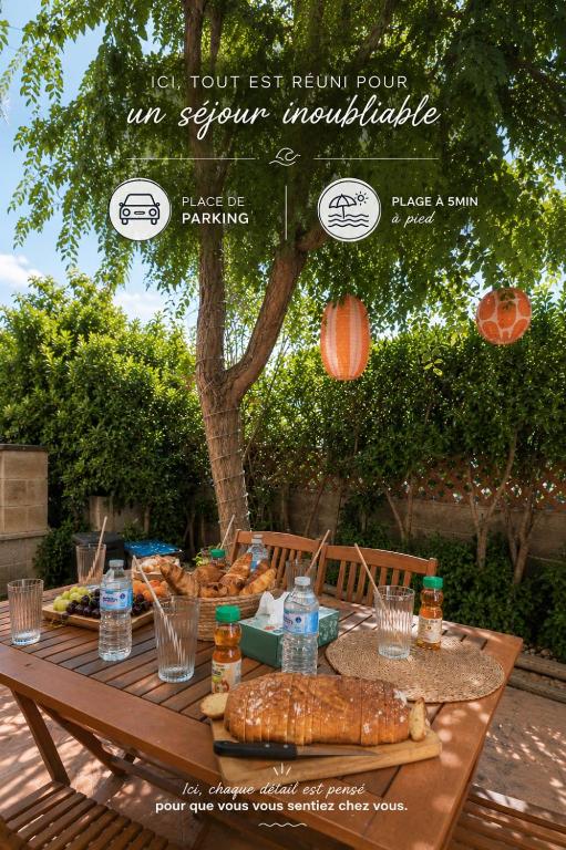 an outdoor table with bread and water bottles on it at Le Cocon Méditerranéen - Plage à 5 min - Place de Parking - Barbecue - Terrasse in Le Barcarès