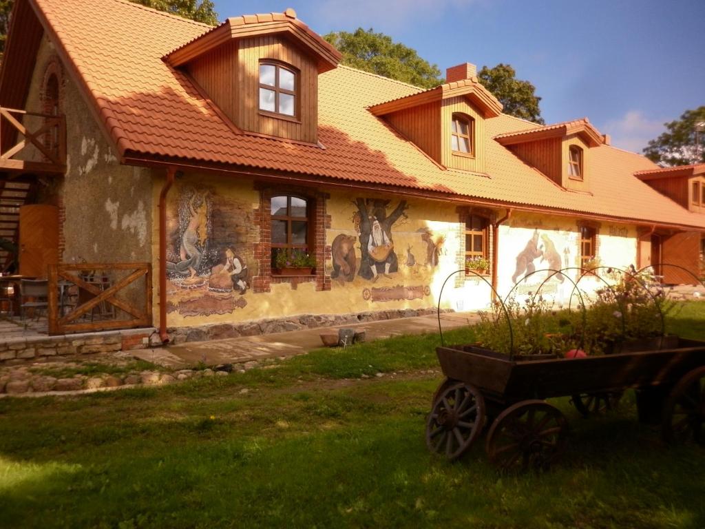a house with a painting on the side of it at Kuldkaru Manor in Valaste