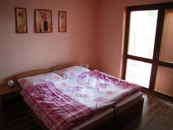 a bed with a blanket on it in a bedroom at Motorest Eso in Vlčkovce
