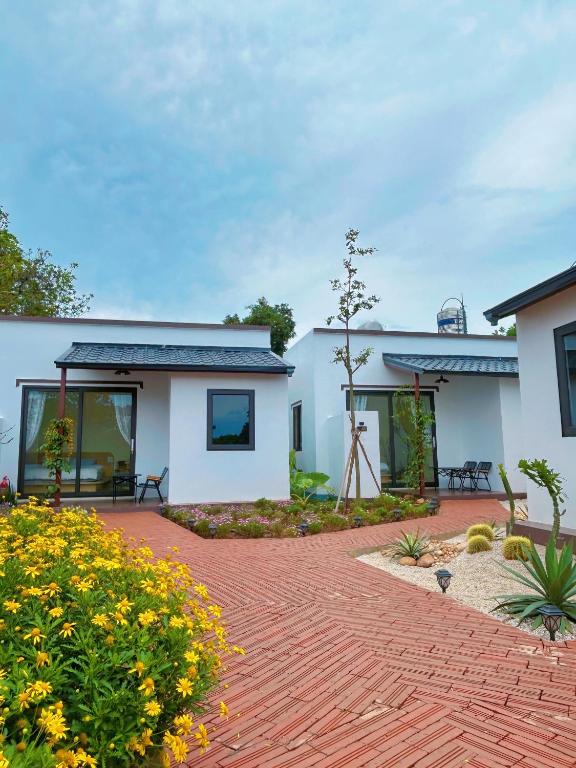 a house with a brick walkway in front of it at Hannie House- Mộc Châu in Mộc Châu