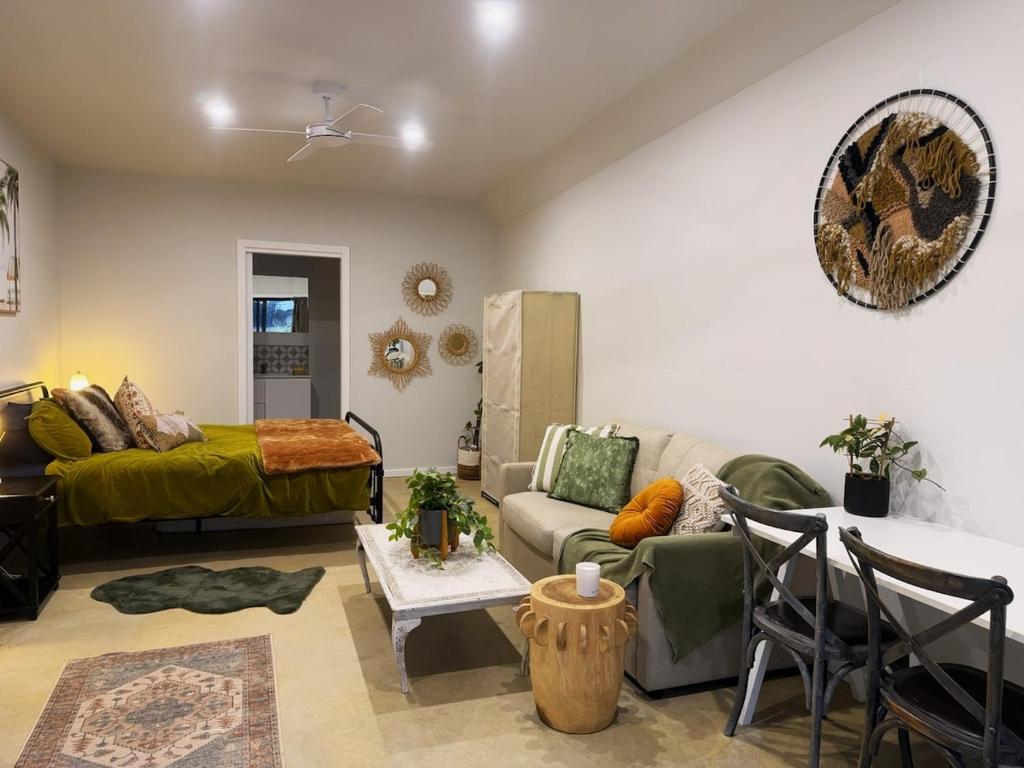 a living room with a couch and a table at Shady Lane - Wallagoot in Jellat Jellat