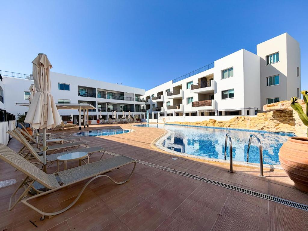 a resort with a swimming pool and a hotel at Chromata Penthouse Apartment in Paralimni