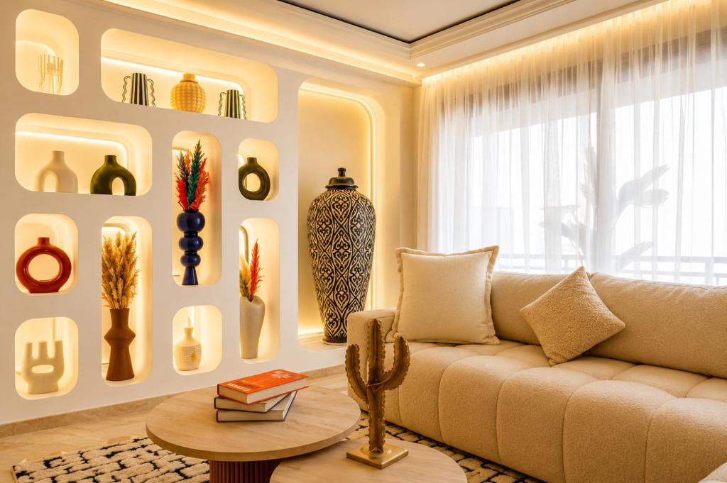 a living room with a couch and vases on the wall at Kasbel 2 Appart & Pool in Marrakesh