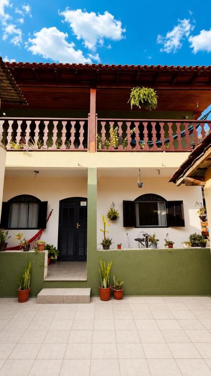 a house with potted plants in front of it at Casa Surya Paraty in Paraty