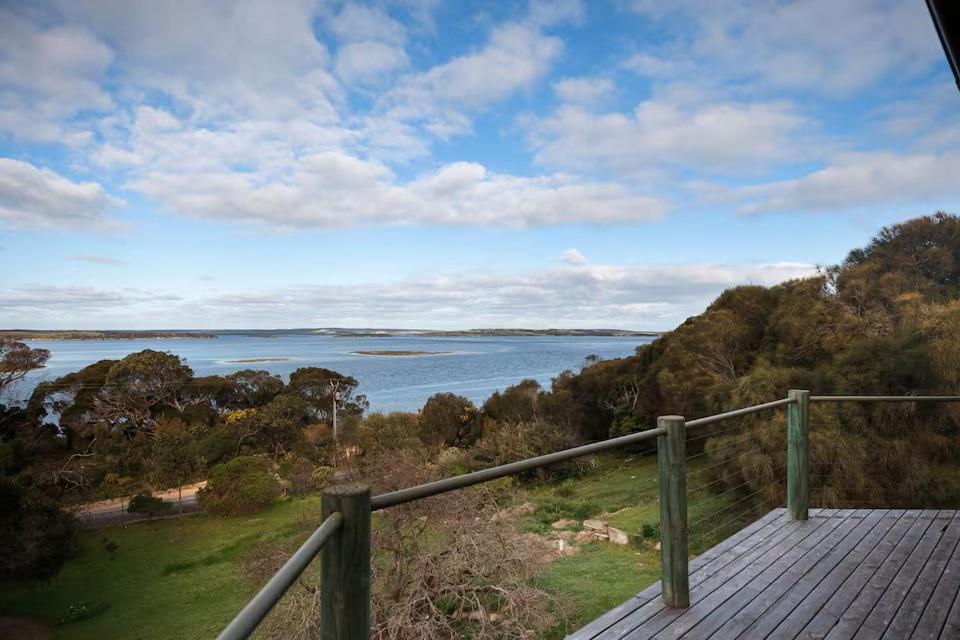 a view of a body of water from a wooden deck at Possum Ridge in Muston