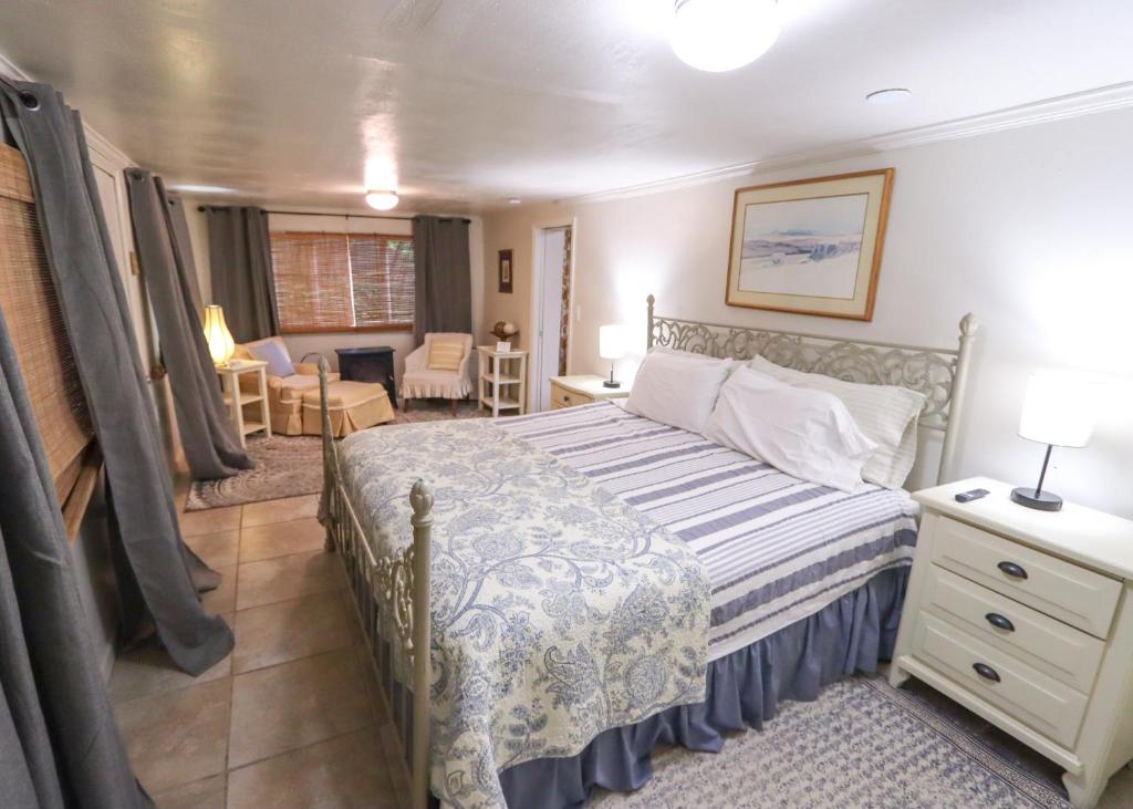 a bedroom with a bed and a living room at Over the Rainbow Suites in Eureka Springs
