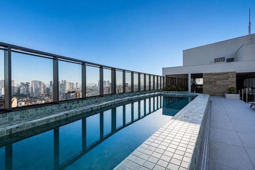 a swimming pool on the roof of a building at GRU Residence by Housi in Guarulhos