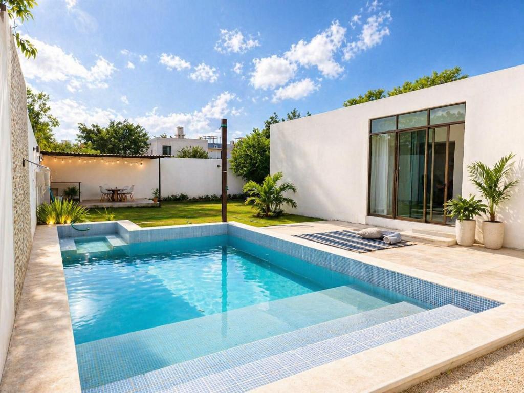 a swimming pool in the backyard of a house at Casa Mayi Private house with pool in Chablekal in Chablekal
