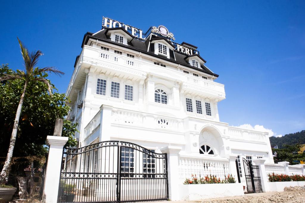 a white building with a black roof at San Franz Hotel La Perla in San Francisco