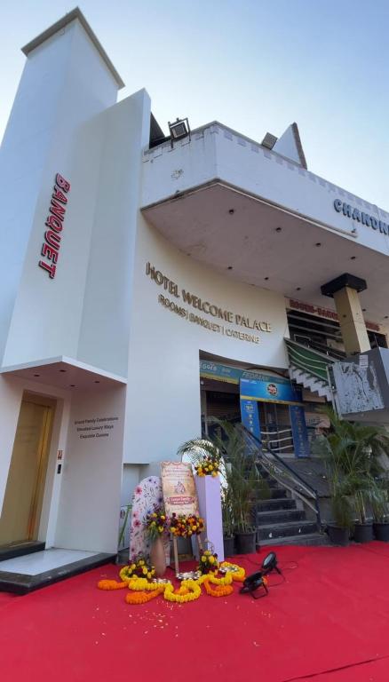 a building with a red carpet in front of it at Hotel Welcome Palace in Surat