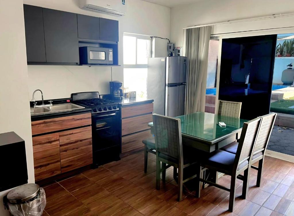 a kitchen with a table and chairs and a refrigerator at Casa Naty in Ciudad Valles