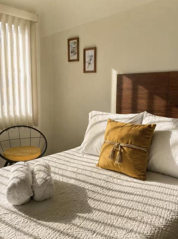 a bedroom with a bed with two pillows on it at Casa Cedro Y Olivo in Gutiérrez Zamora