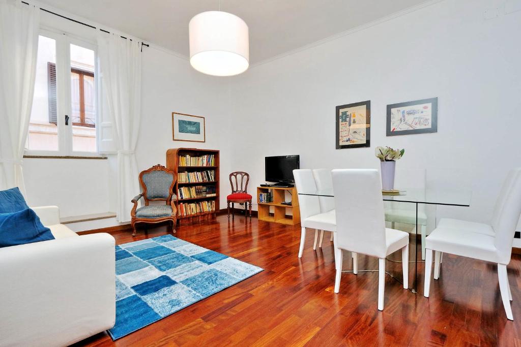 a living room with a table and white chairs at RomeAsYouLike-Monti Experience 295 in Rome