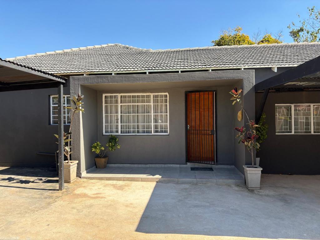 a home with a red door and a patio at Phapel Home-Away in Pretoria