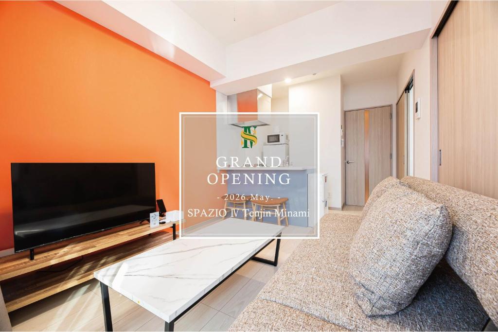 a living room with a flat screen tv and a couch at SPAZIO 4 Tenjin Minami in Fukuoka