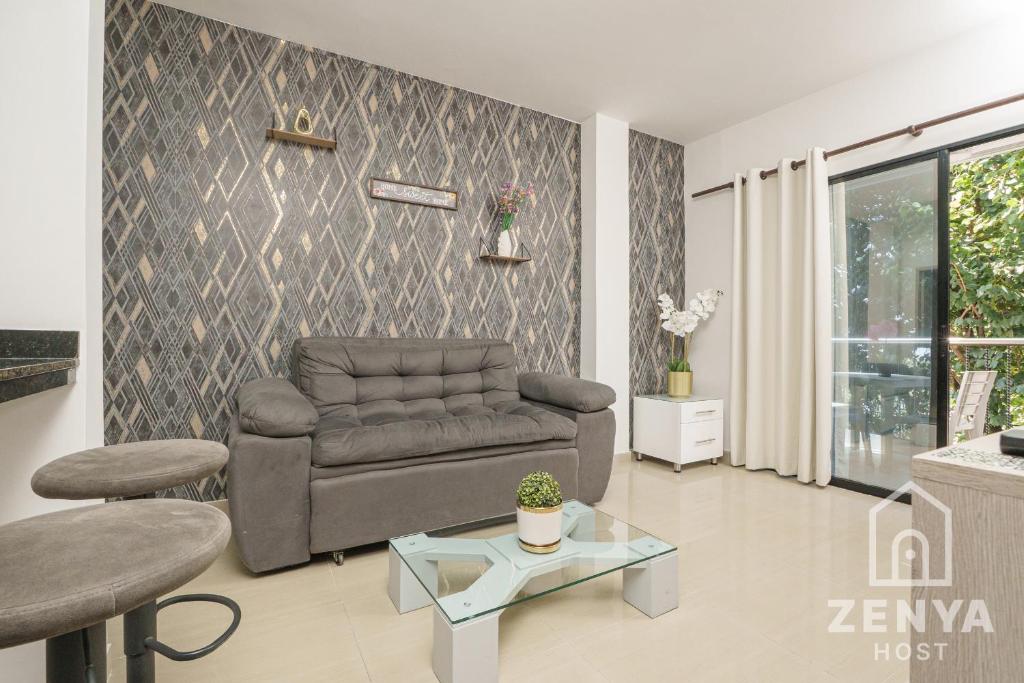 a living room with a couch and a table at Hotel On By Zenya Host in Cali