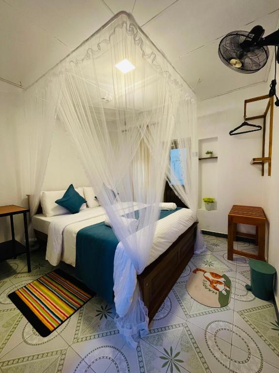 a bedroom with a bed with mosquito netting at Ella Solara Heaven in Ella