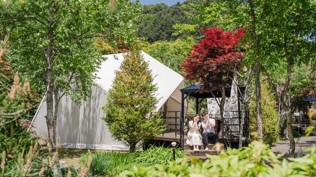 a group of people walking in front of a tent at Gapyeong Pine4rest Glamping in Gapyeong