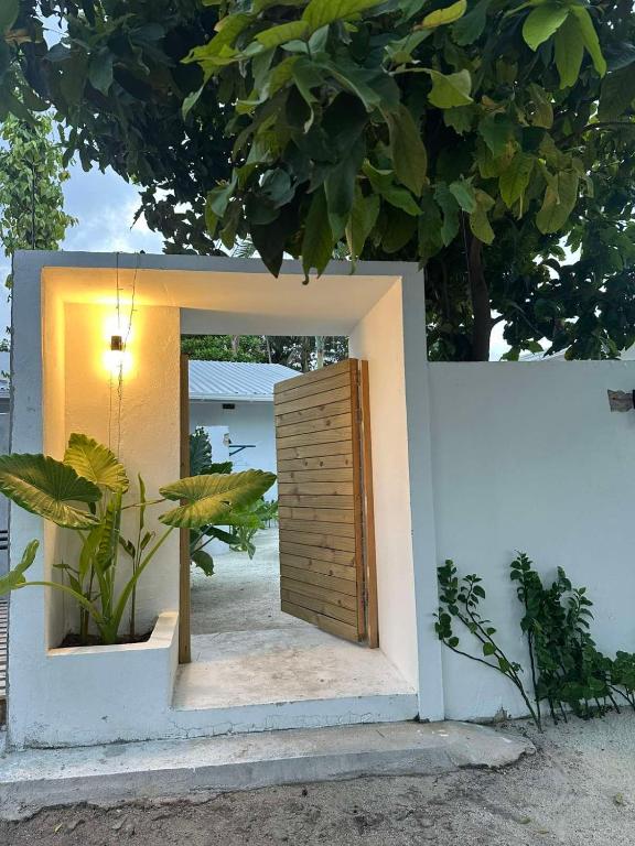 a doorway into a house with a wooden door at Salt Serenity in Thoddoo