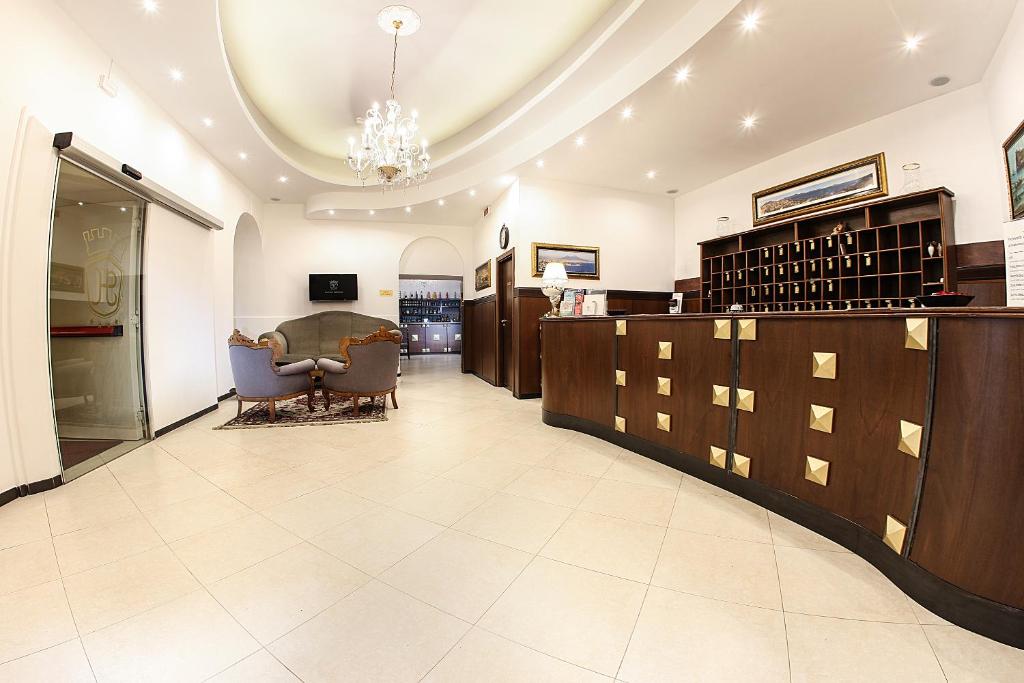 a lobby with a waiting area with a table and chairs at Grand Hotel Capodimonte in Naples