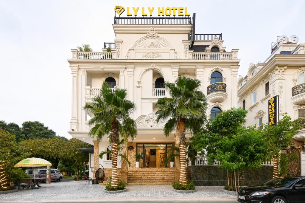 a building with palm trees in front of it at Ly Ly Luxury Hotel in Ho Chi Minh City