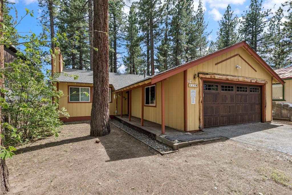 a house with a garage and a tree at 838 Placer Avenue home in South Lake Tahoe