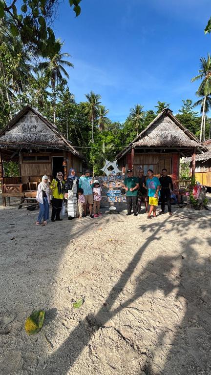 a group of people standing in front of buildings at Saubaryam Home stay in Fam