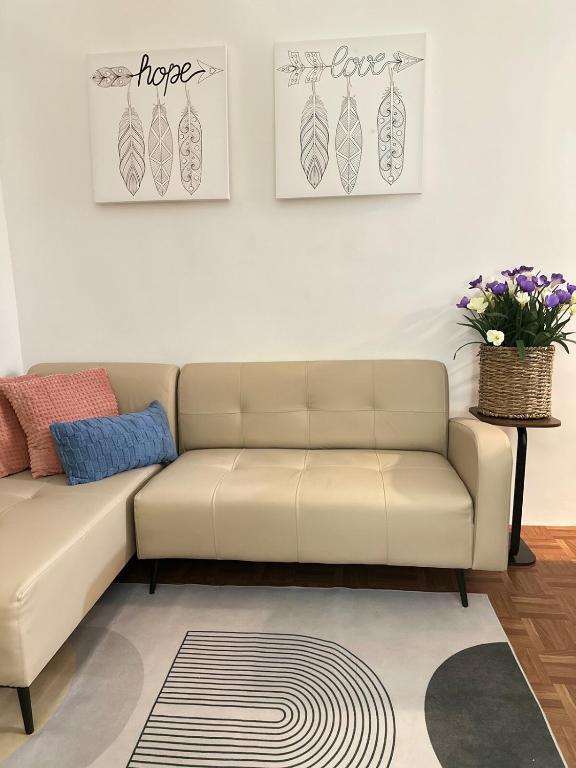 a living room with a couch and two pictures on the wall at Mellow Place Staycation in Naic