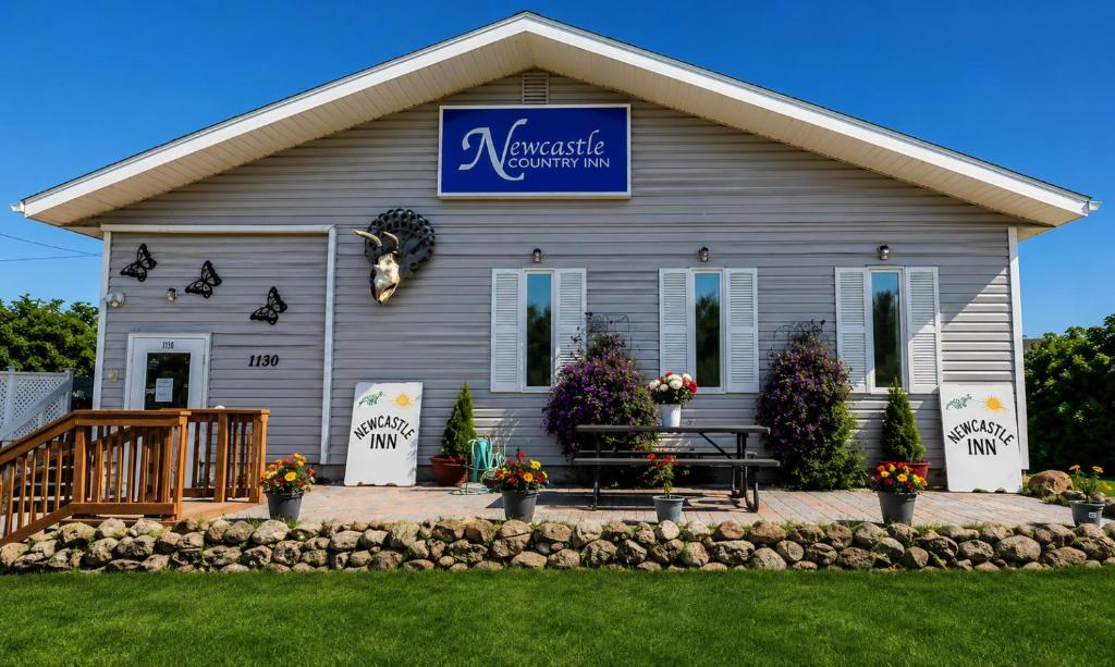 a house with a sign that reads embassy community at NEWCASTLE COUNTRY INN in Drumheller