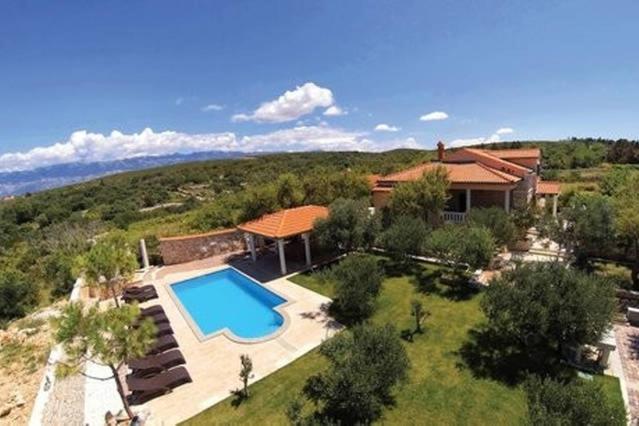 an aerial view of a house with a swimming pool at Villa Dabo in Novalja