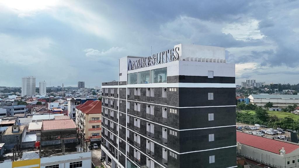 a building with a sign on the top of it at SleepRest Azure Suites in Bagam