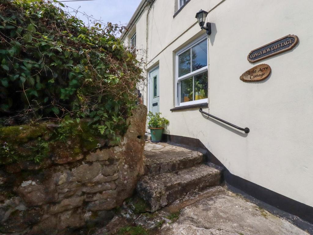 a stairway leading up to a building with a window at Longview Cottage in Bugle