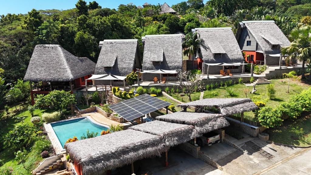 an aerial view of a resort with a pool and roofs at lodges cap dore in Andilana