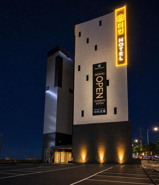 a building in a parking lot at night at Gwangju The IN Hotel in Gwangju