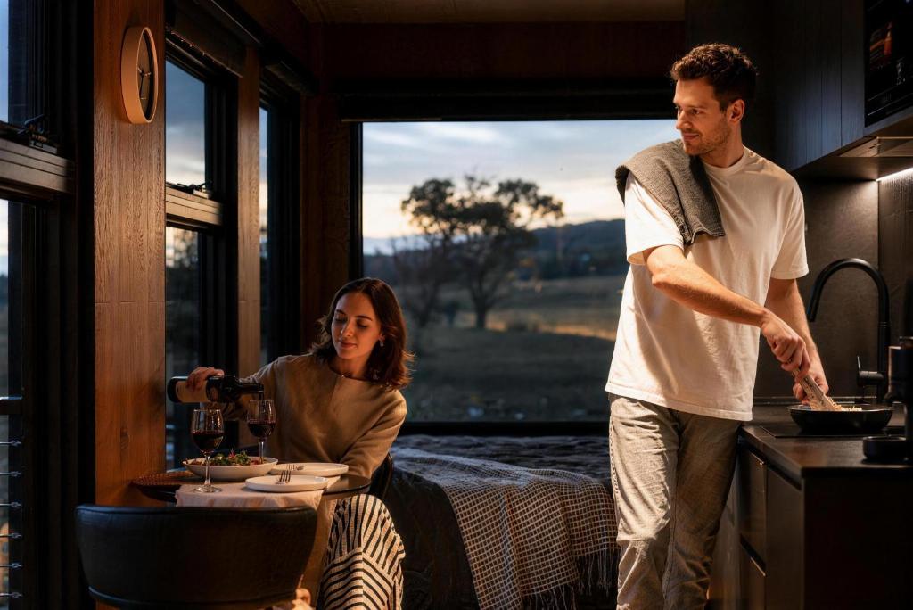 a man and a woman standing in a kitchen at AUTRA Resort Middleton in Middleton