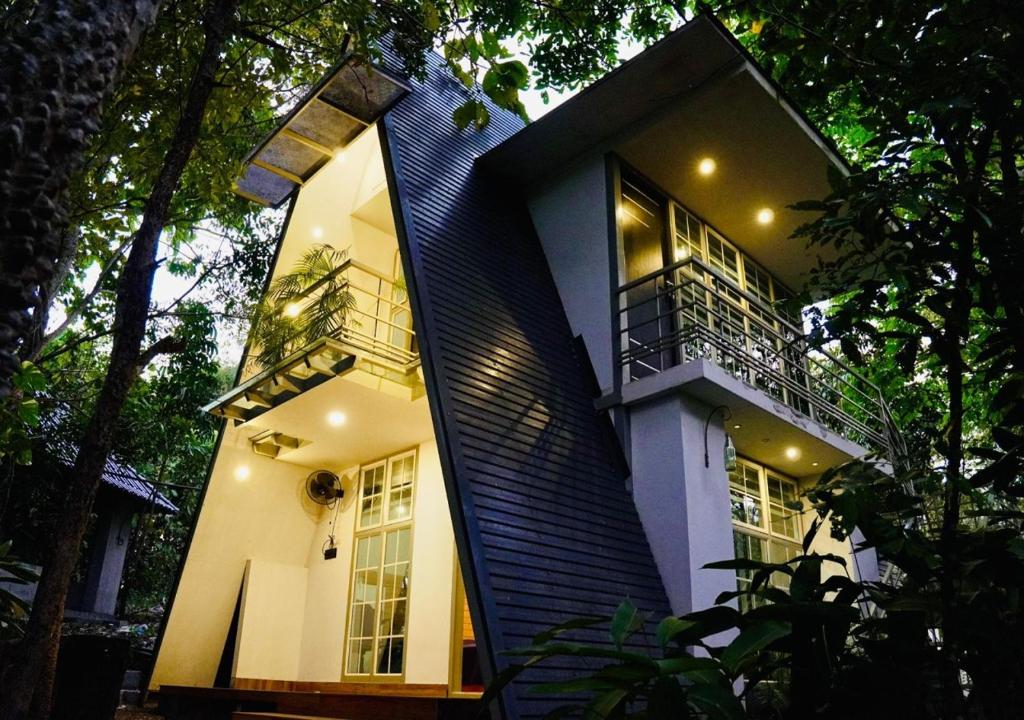 a house with a staircase leading up to it at Poomala Holiday Village in Mulagunnathukāvu
