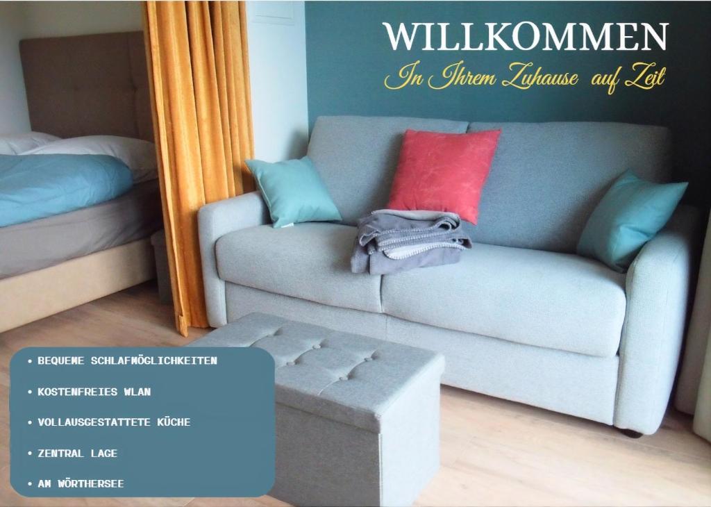 a living room with a couch and a bed at Lakeside Central Apartment Wörthersee - Free covered Parking, Train & Bus & Supermarket with Supercharger in Sekull